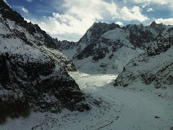 Scenic view of mountains against cloudy sky