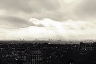 Buildings against cloudy sky