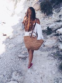 Rear view of woman standing on street