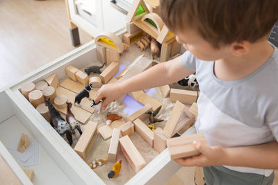 High angle view of boy playing on table