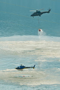 Helicopters flying over sea