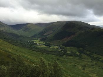 Scenic view of mountains against cloudy sky