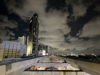 Illuminated buildings against sky at sunset