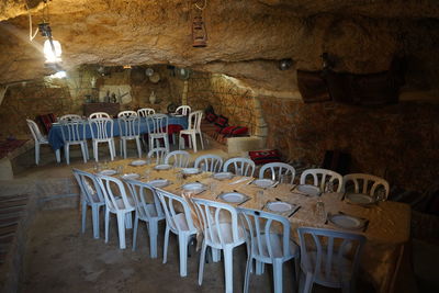 Empty chairs and tables in row
