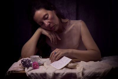 Woman in romantic attitude reading a love letter