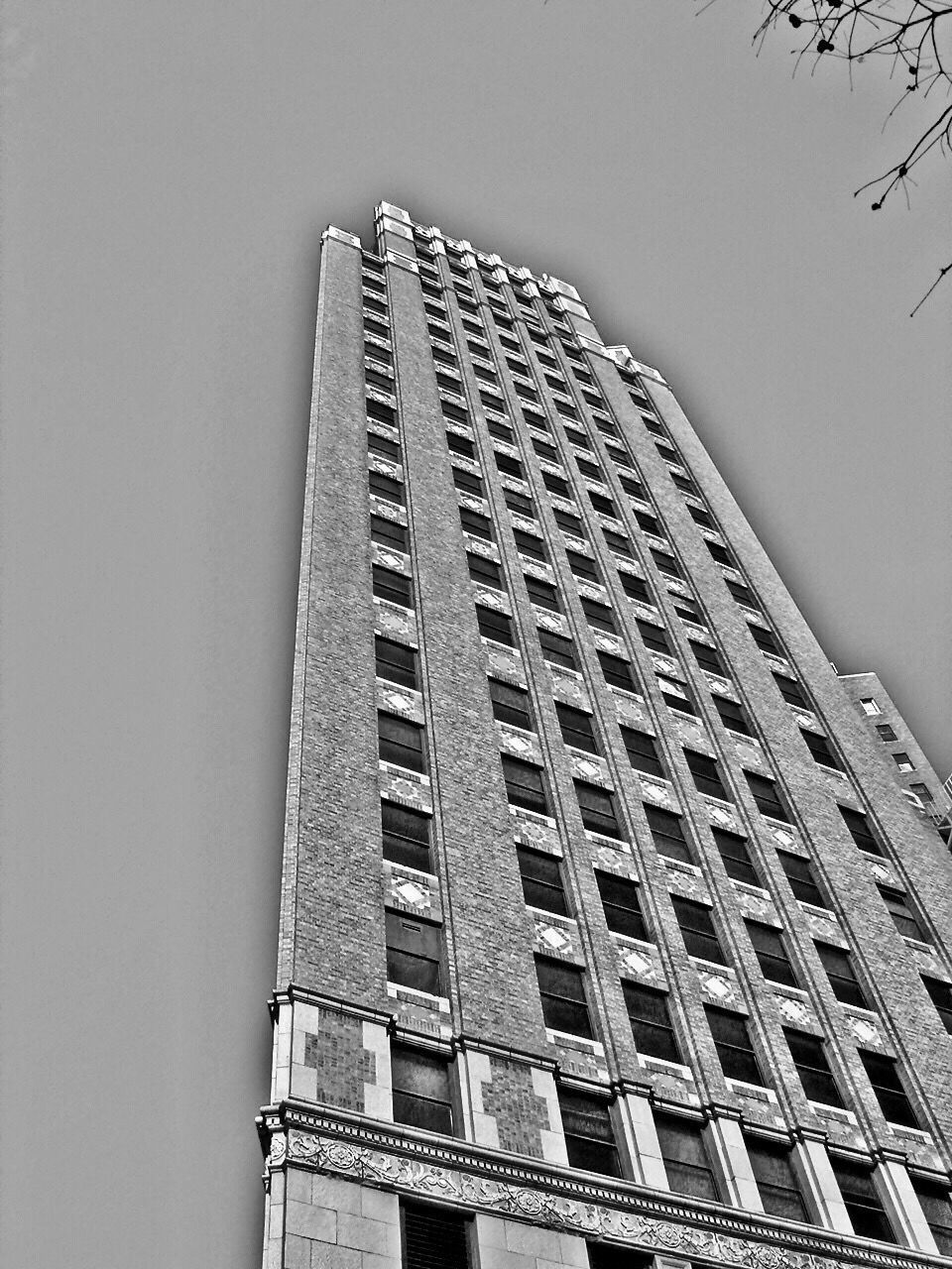 LOW ANGLE VIEW OF OFFICE BUILDING AGAINST CLEAR SKY