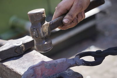 Close-up of man working on metal