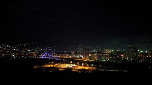 High angle view of illuminated buildings in city at night