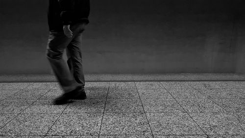 Low section of man walking on street