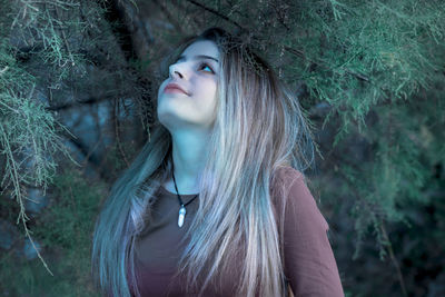 Close-up of woman looking away in forest