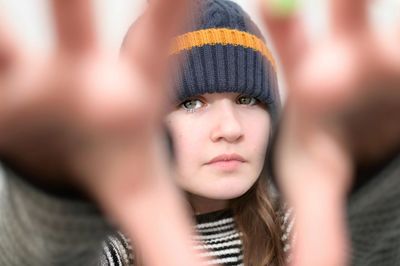 Close-up portrait of girl wearing knit hat