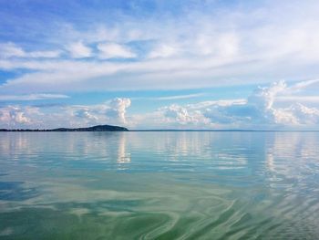 Scenic view of sea against cloudy sky