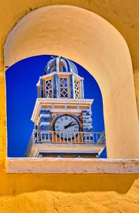 Low angle view of clock tower against building