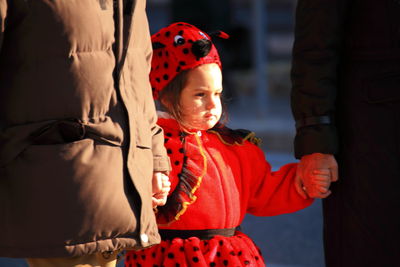 Portrait of cute baby girl in traditional clothing during winter