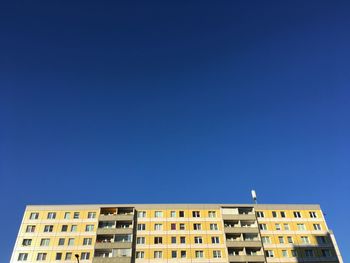 Low angle view of building against clear blue sky