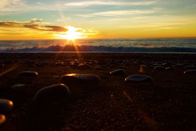 Close-up of sea against sky during sunset