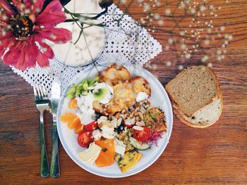 Directly above shot of breakfast served in plate on wooden table at home