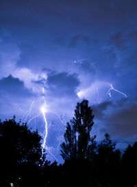 Low angle view of lightning in sky at night