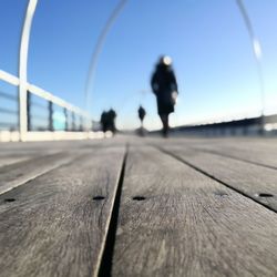 Close-up of person walking against clear sky