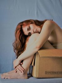 Portrait of beautiful woman sitting in box