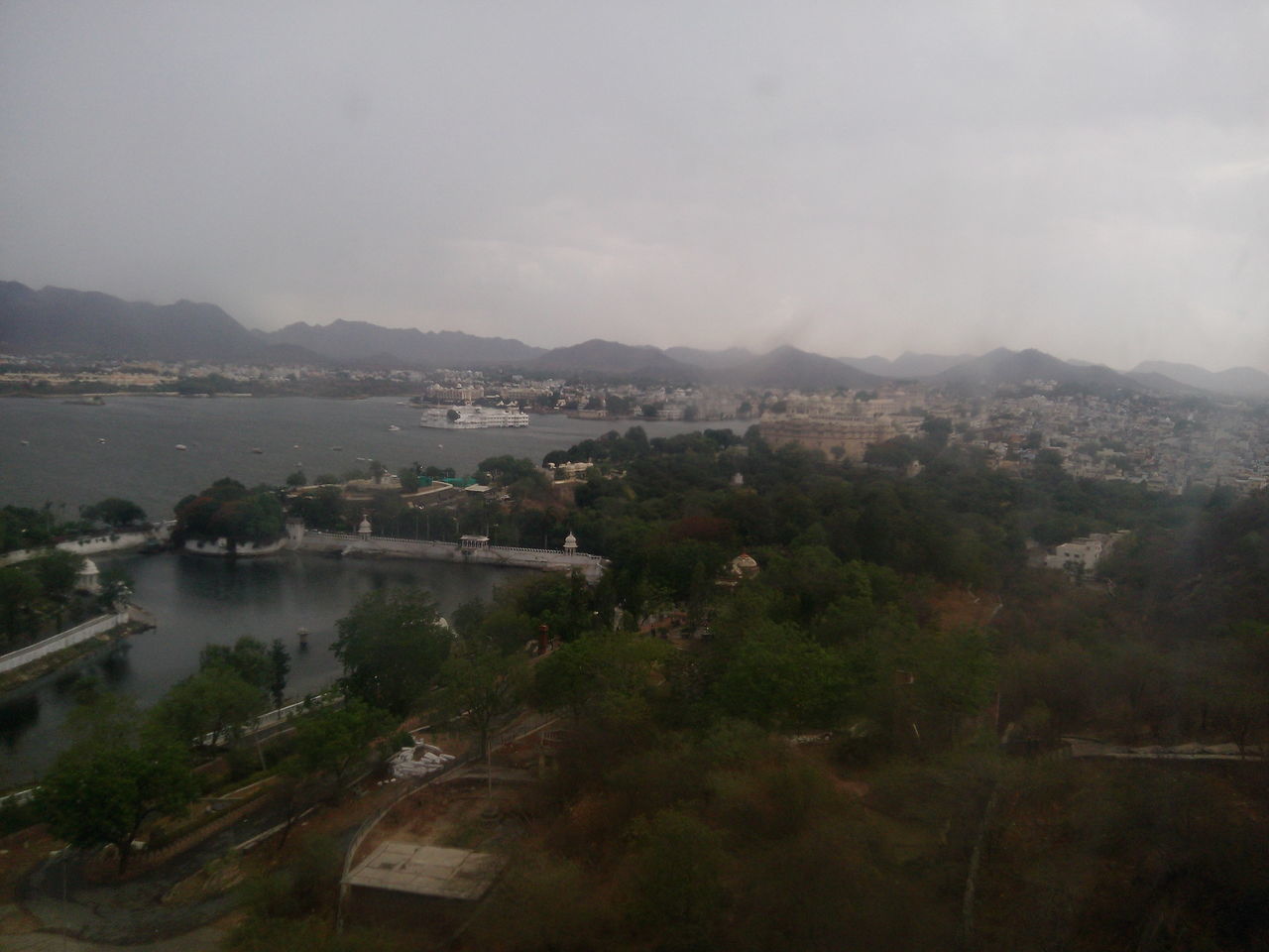 HIGH ANGLE VIEW OF RIVER BY CITY AGAINST SKY