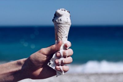 Close-up of hand holding ice cream cone