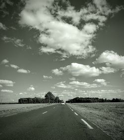 Road by landscape against sky