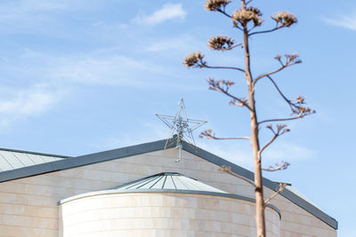 Low angle view of traditional windmill against sky