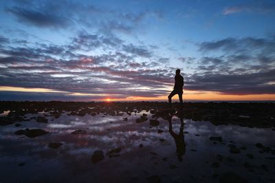 Silhouette of woman standing on beach