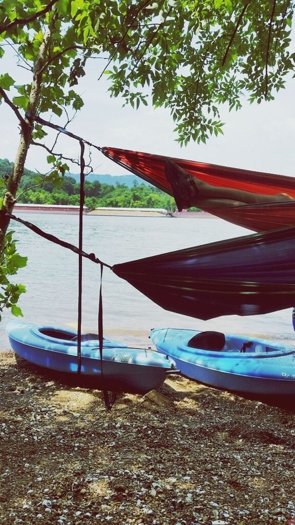 water, tree, transportation, nautical vessel, tranquility, boat, day, nature, sky, tranquil scene, river, lake, outdoors, beach, built structure, clear sky, moored, sea, no people, beauty in nature