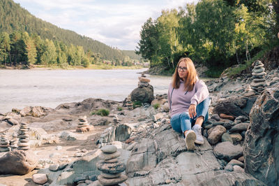 Portrait of woman sitting on rock