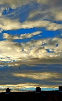 Low angle view of silhouette building against sky during sunset