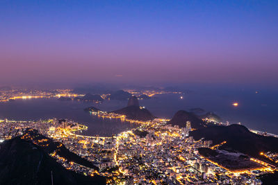 High angle view of illuminated buildings in city at night