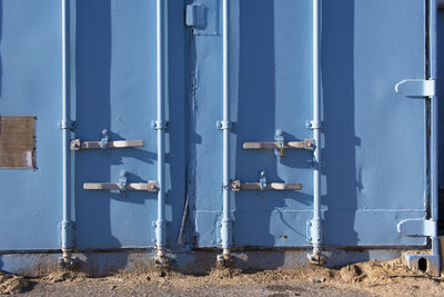 Close-up of pipes against blue wall