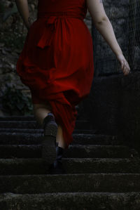 Low section of woman walking on staircase