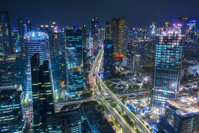 High angle view of illuminated modern buildings in city at night