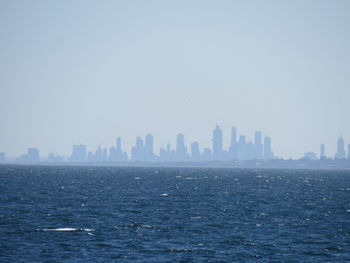 Scenic view of sea and buildings against sky
