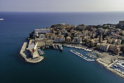 High angle view of buildings by sea against sky