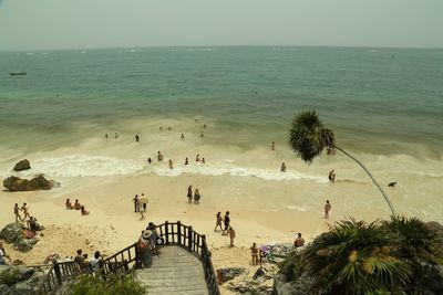 High angle view of people on beach against clear sky