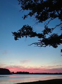 Scenic view of silhouette trees against sky at sunset