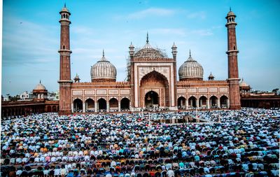 High angle view of people praying in front of mosque