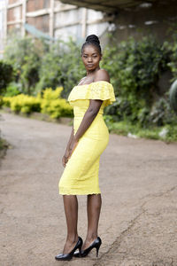 Full length portrait of woman standing on land