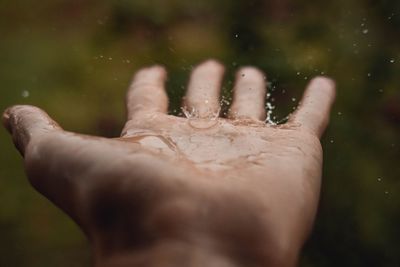 Close-up of hand on wet glass