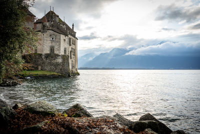 Building by sea against sky