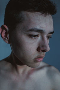 Close-up portrait of shirtless man