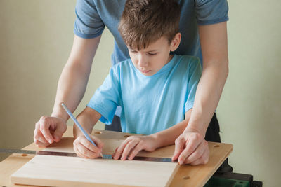 Full length of a boy holding table