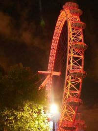 Low angle view of ferris wheel against sky at night