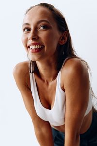 Portrait of young woman against white background