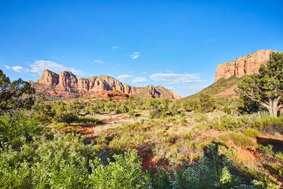 Scenic view of mountains against clear blue sky