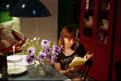 Young woman sitting on table